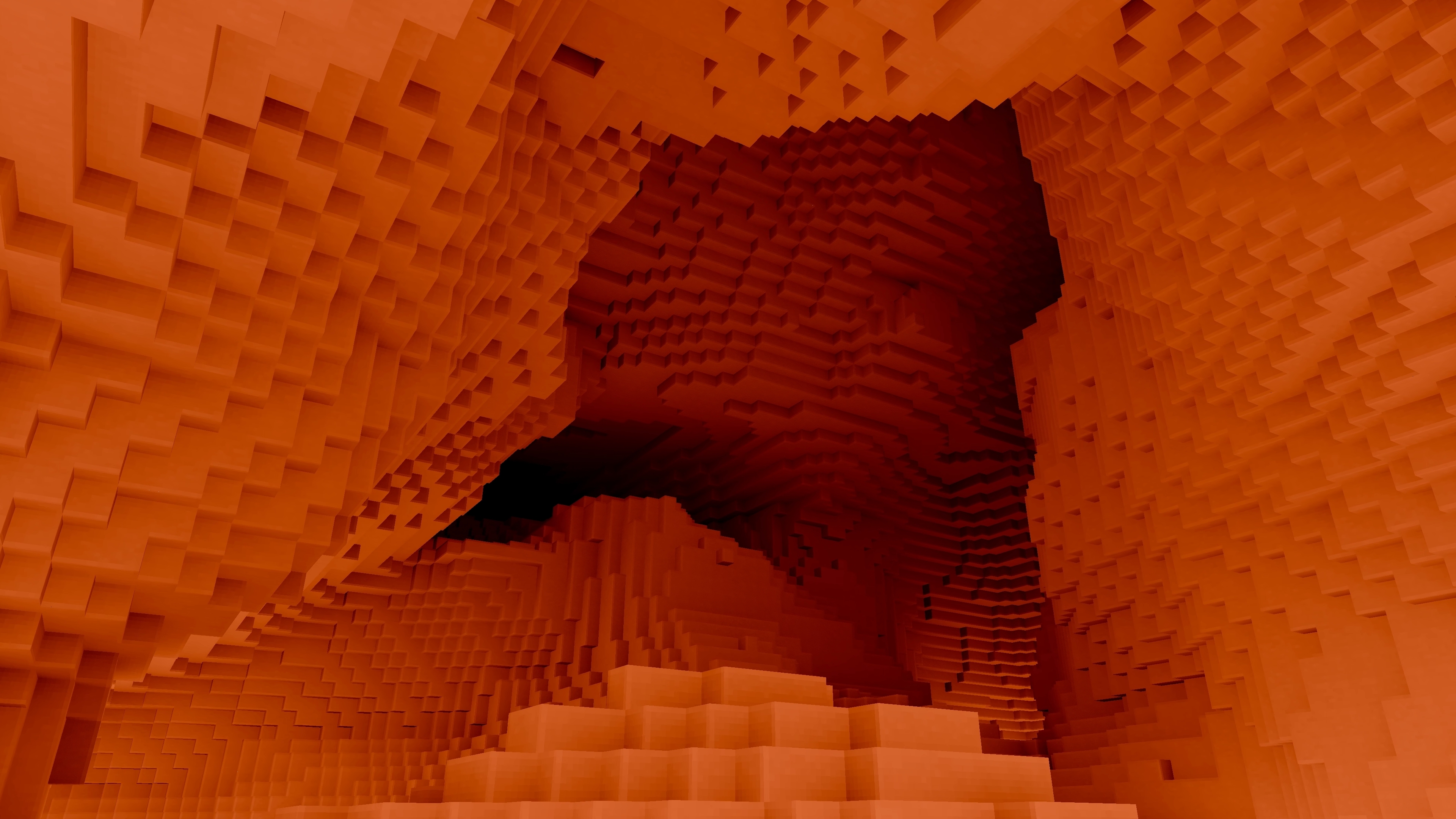 A deep cave lit by offscreen magma